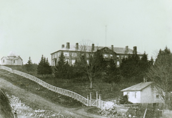 Fig. 1—An early photograph of the First Astronomical Observatory in Canada, located on the campus of the University of New Brunswick. In addition, the Arts Building which is the oldest existing university building in Canada, is also shown. (Photo: UA PC9 no.6(d) )