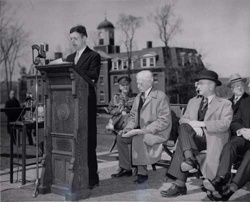 Bailey reads a poem at the podium