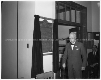 Winslow Plaque in its former location, the Bonar-Law Bennett Library, taken during the plaque's official unveiling ceremony in 1957. UA RG 340; Series 1; File 1957-37B. Photo Credit: Joe Stone and Son Ltd.