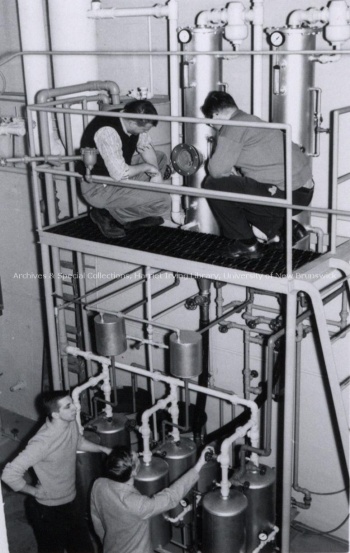 Men looking at research equipment in the Chemical Engineering Building. Record group/Fonds UA PC; Series UA PC 9a; Item no. 17 (2) March 1961.