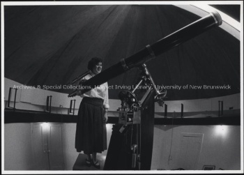 Civil Engineering student Elizabeth Pugh with telescope in the restored Brydone Jack Observatory. Record group/Fonds PR; Series 2; Sub-series 3; File 677; Item no. 6 April 1985.