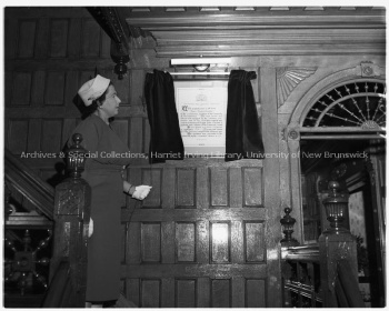 Muriel Farris Baird unveiling the illuminated scroll at Maggie Jean Chestnut Residence, Oct. 1957. UA RG 340; Series 1; Box 1: 1245 - 3632, File 1957-45B, a. Photo by Joe Stone and Son Ltd.