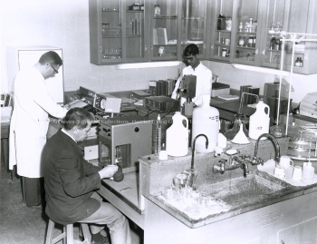 Group of three men, conducting experiments in the Biology Department. UA PC; Series UA PC 9; Item no. 56 (7) [19--]