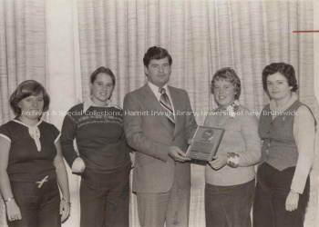 Eric Garland presents a gold award to officers of the Nursing Society, 1977. PR; Series 1; Sub-series 2; Item 5377.