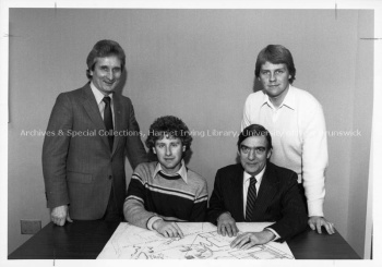 SRC members and UNB representatives look over architectural plans for the UNBSJ Student Centre. PR; Series 2; Sub-series 4; File 947; Item 6 1983